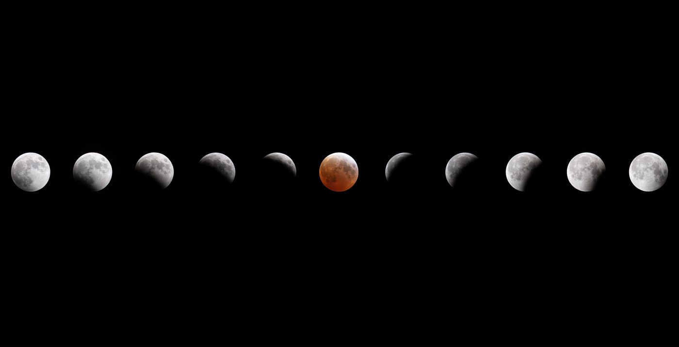 Eleven Moons in a row across a black sky. They grow darker toward the middle, where one Moon is coppery red.